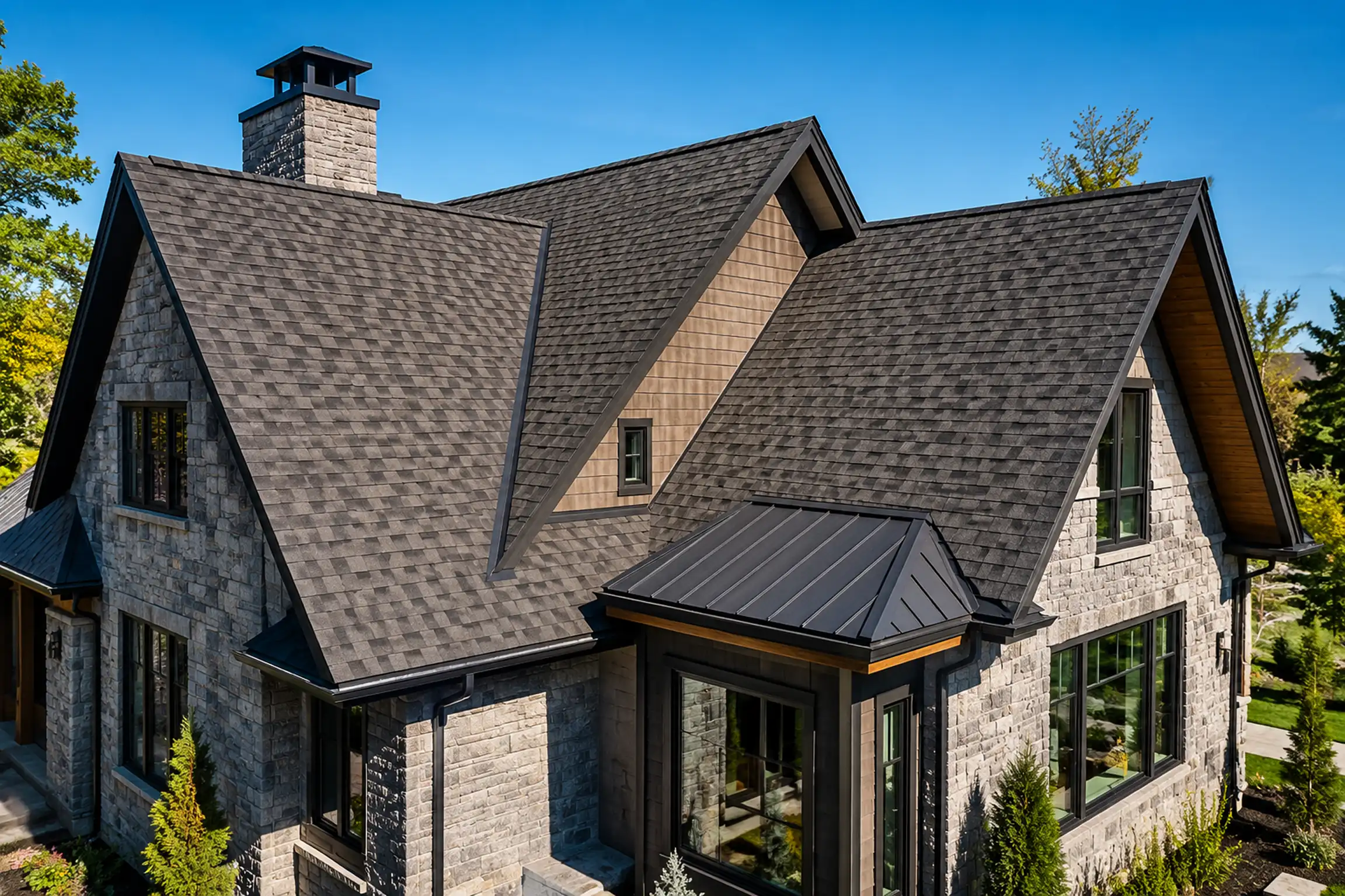 GTA home featuring steep slope asphalt shingle roofing with a standing seam metal roof accent